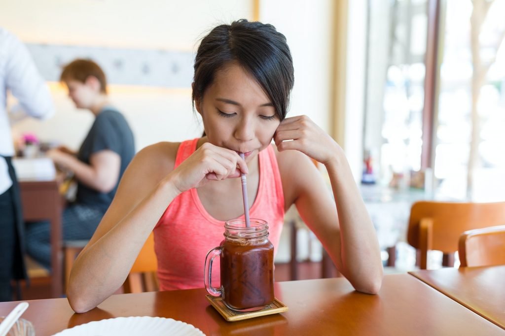 Sport woman enjoy iced coffee in cafe