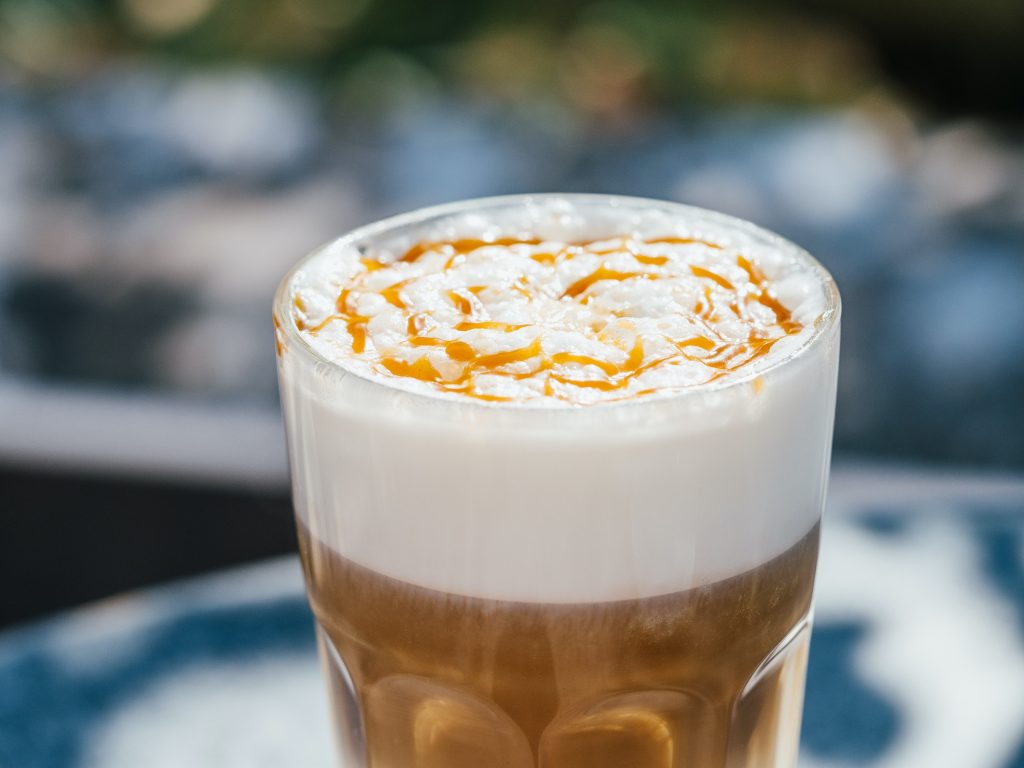 Hot latte macchiato coffee with caramel outdoor
