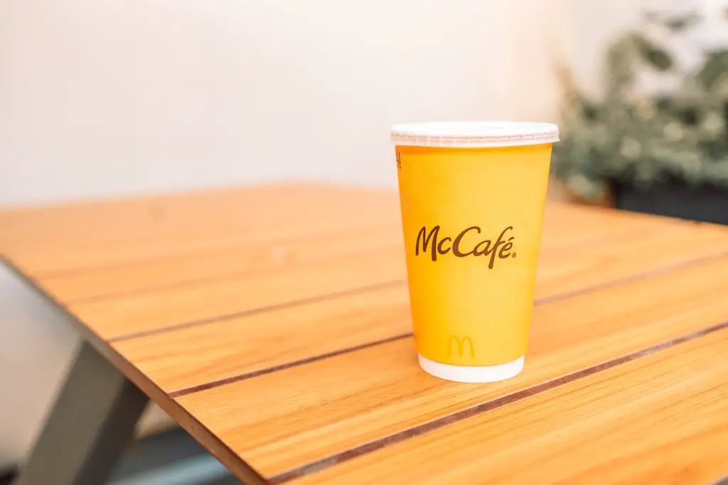 Krakow, Poland - 25 August 2022: McDonald's coffee cup. Disposable fast food dishes. Paper cup.