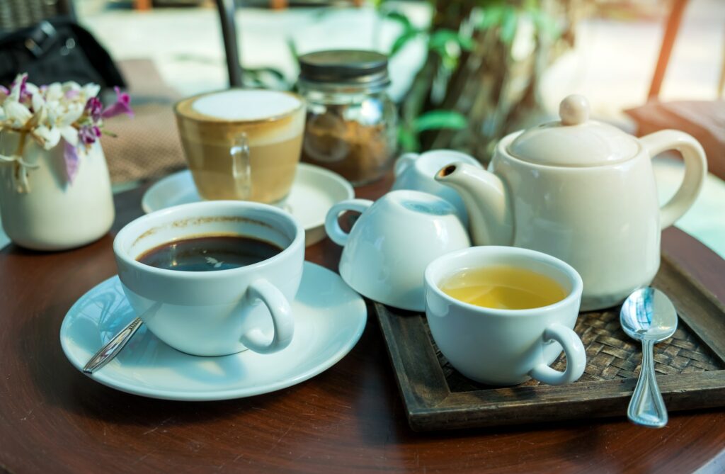 Coffee and Tea on wooden table.Glass tea placed in a wooden tray.