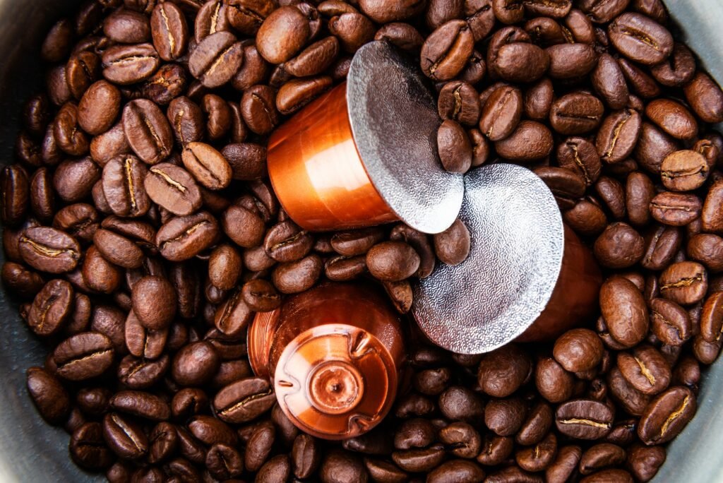 Espresso coffee capsules or pods and coffee beans on wooden rustic background