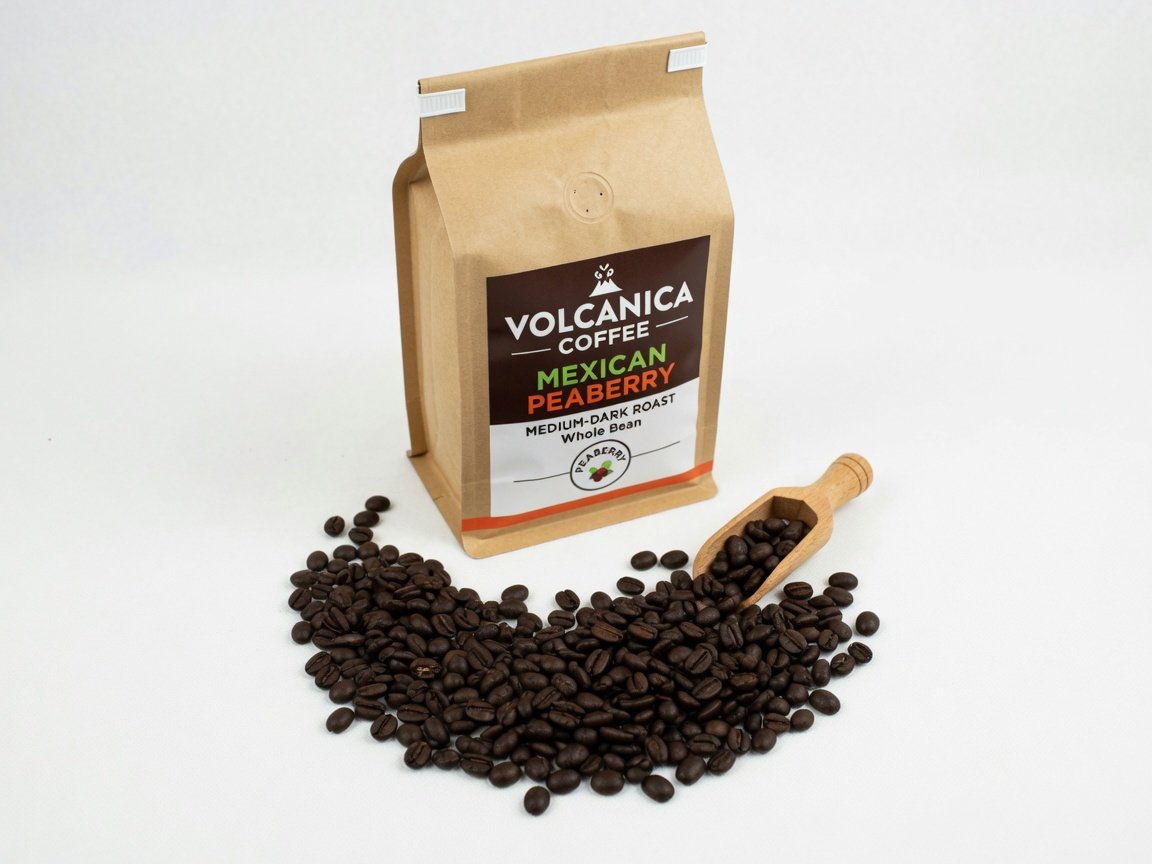 A sealed kraft bag of Volcanica Coffee Mexican Peaberry roast with a small scoop of dark medium-roast beans spilling